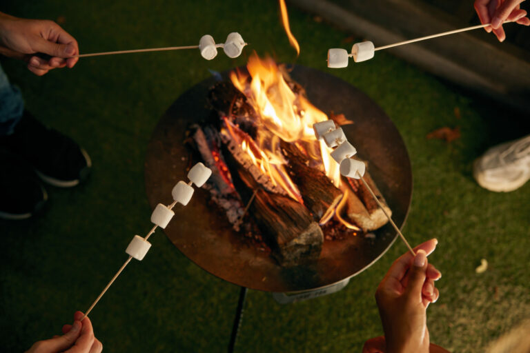 Marshmallows being toasted over a flame. A fire pit is one of our many site facilities.